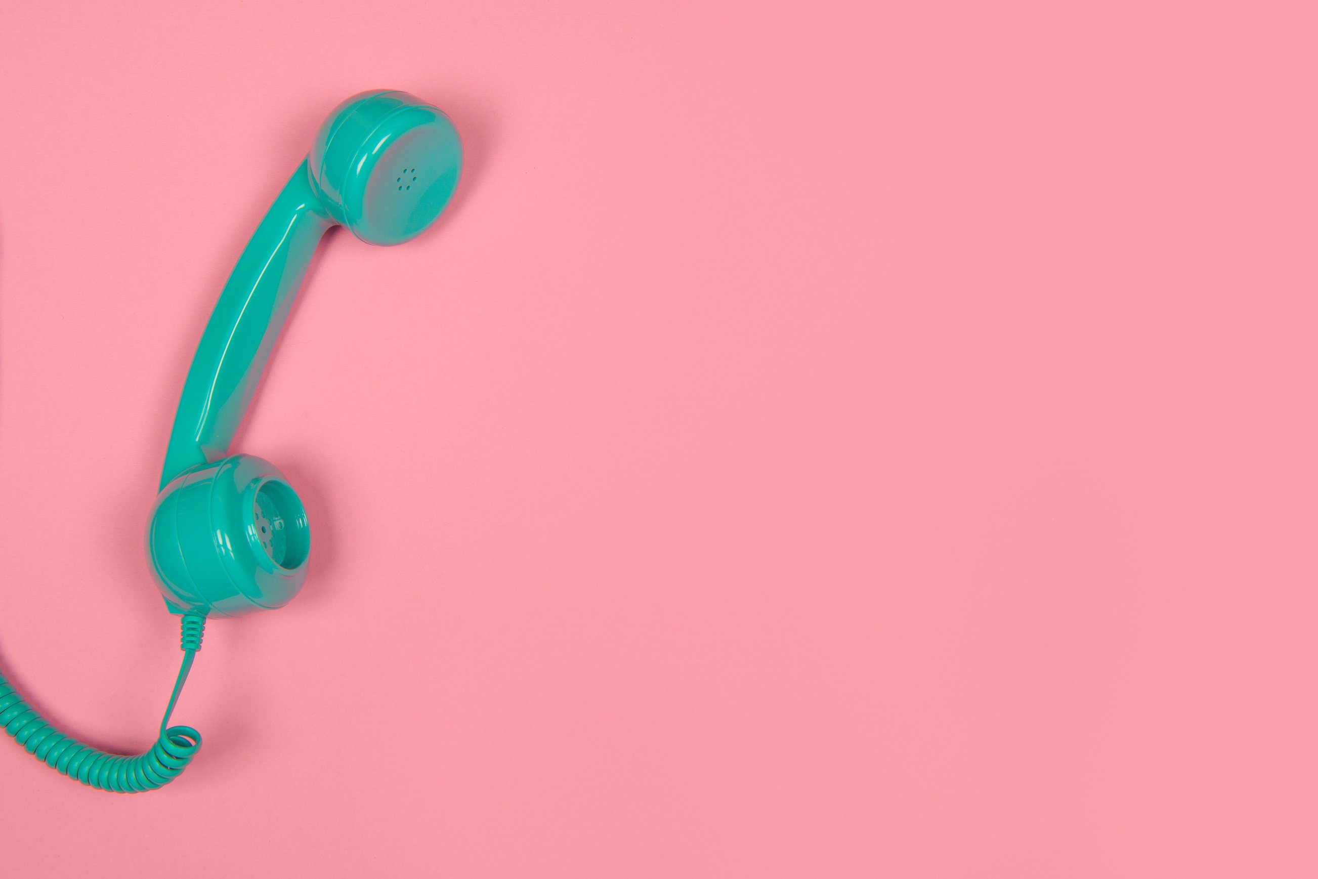 Teal Retro Telephone on Pink Background